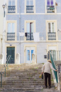 Façade recouverte d'azulejos, vieil escalier et habitant de Lisbonne, Portugal